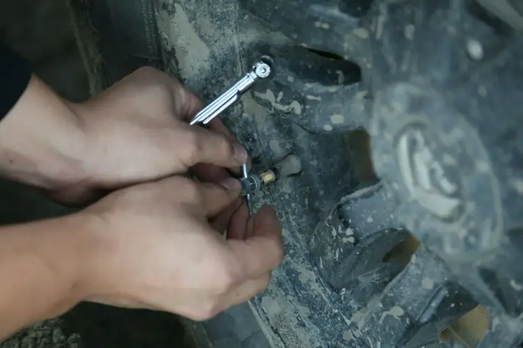 Car tyre maintenance and inspection as part of road trip vehicle preparation.