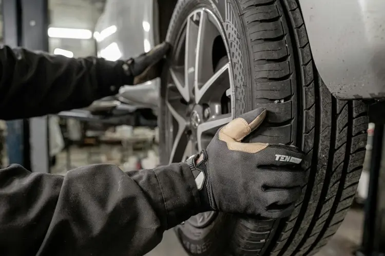 Checking tyre pressure before a long highway drive.