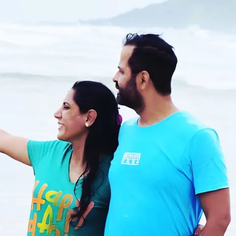 Poonam and Sunil, the couple behind Keys & Miles, on a beach